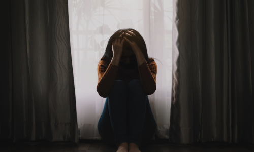 Person sitting in dark room